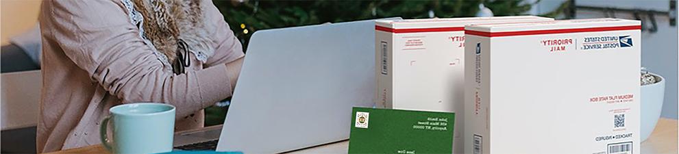 A woman preparing to ship holiday gifts with a Priority Mail Express box and a Priority Mail box.